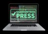 Laptop that displays "Guaranteed Press" across the screen
